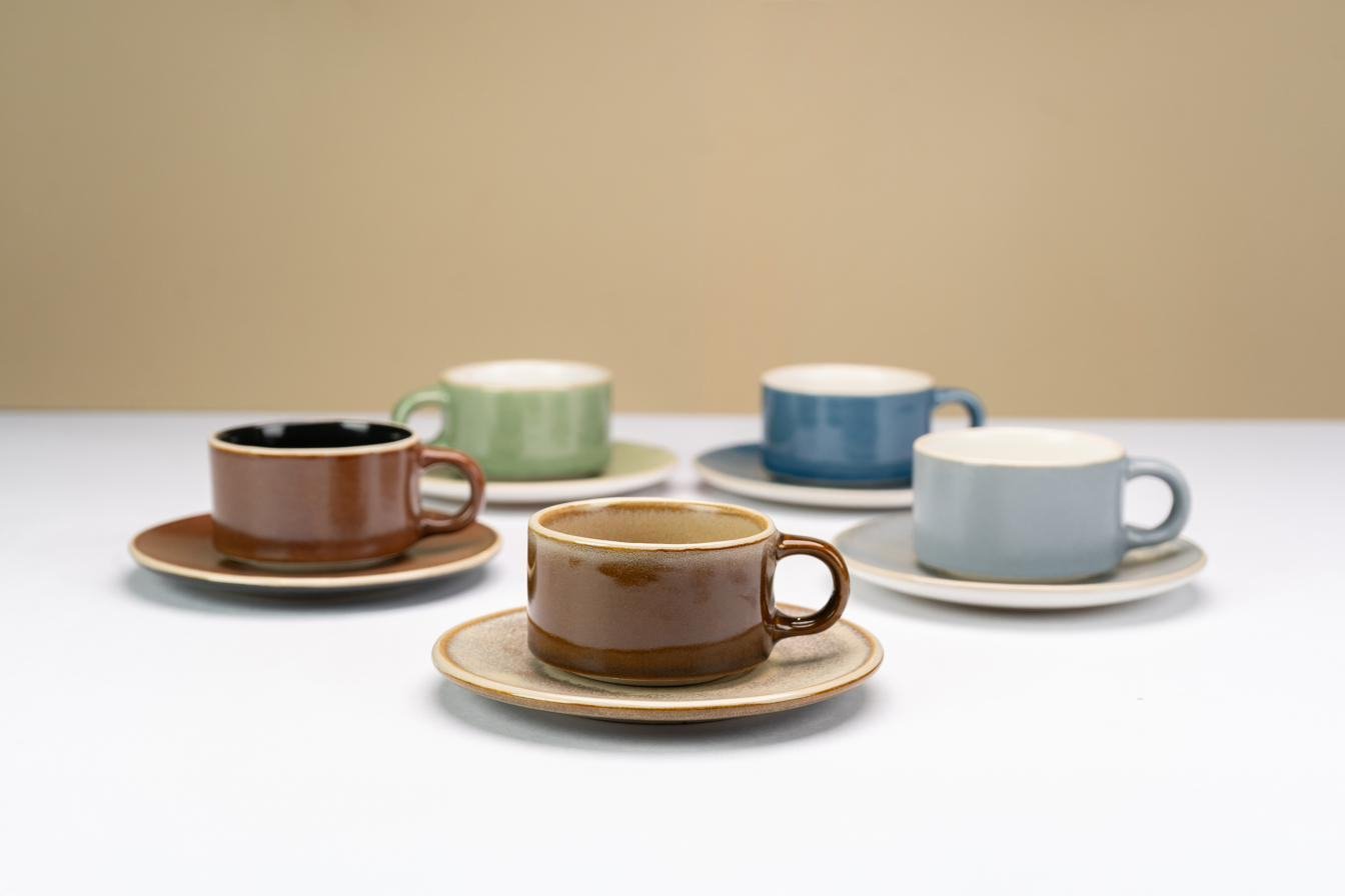 Handmade stoneware cups and saucers in mixed glazes