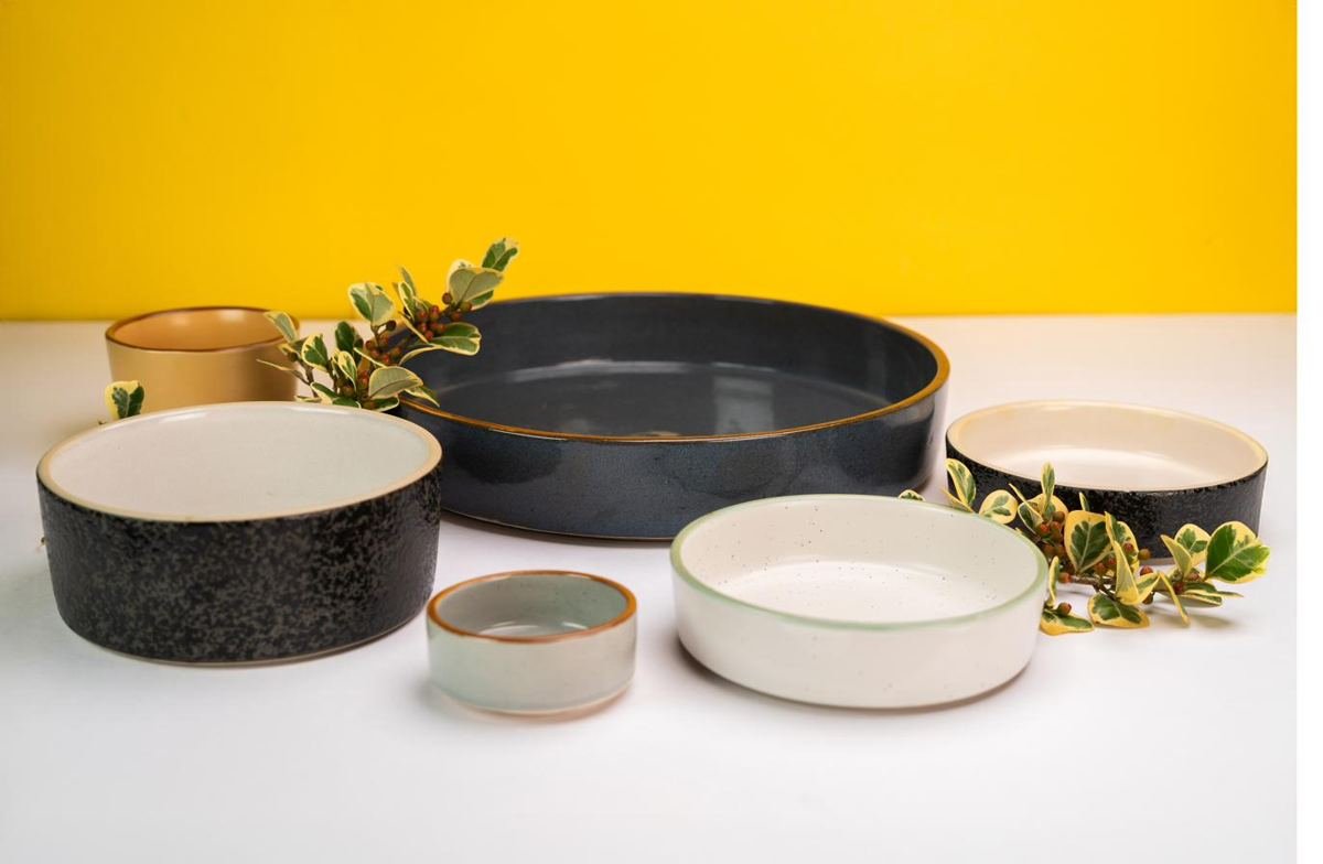 Stacked handmade stoneware serving bowls ready for restaurant service