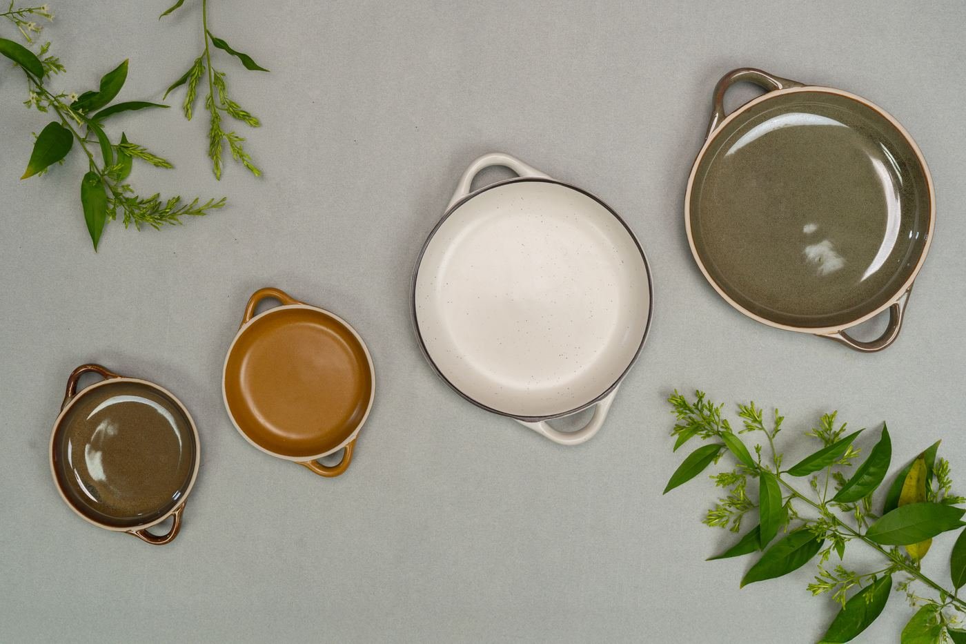 Handled serving dishes in olive, ochre and speckled white