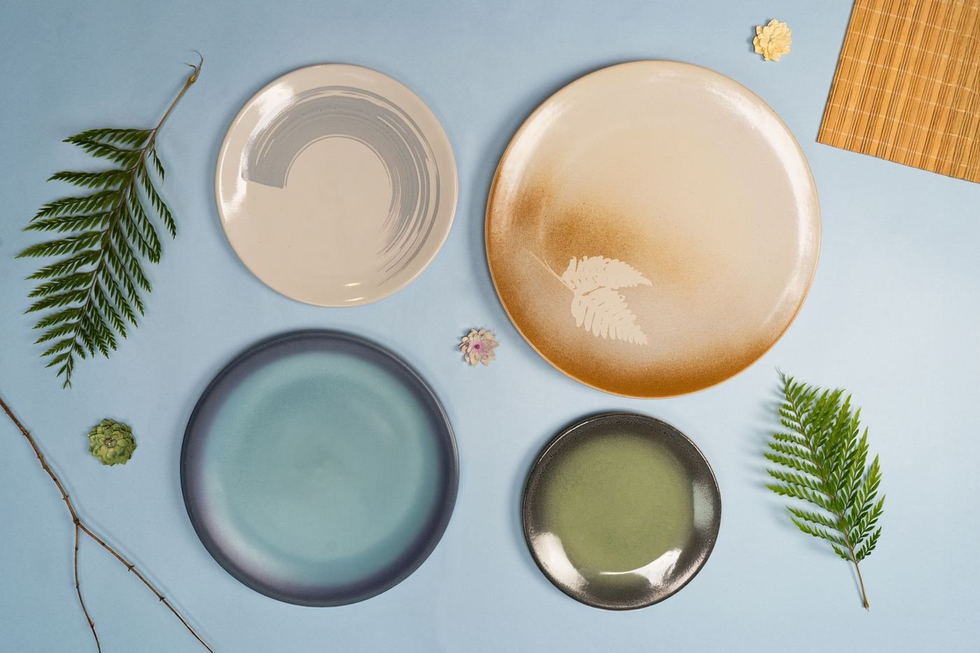 Brushstroke, fern-print and ombré plates on pale blue