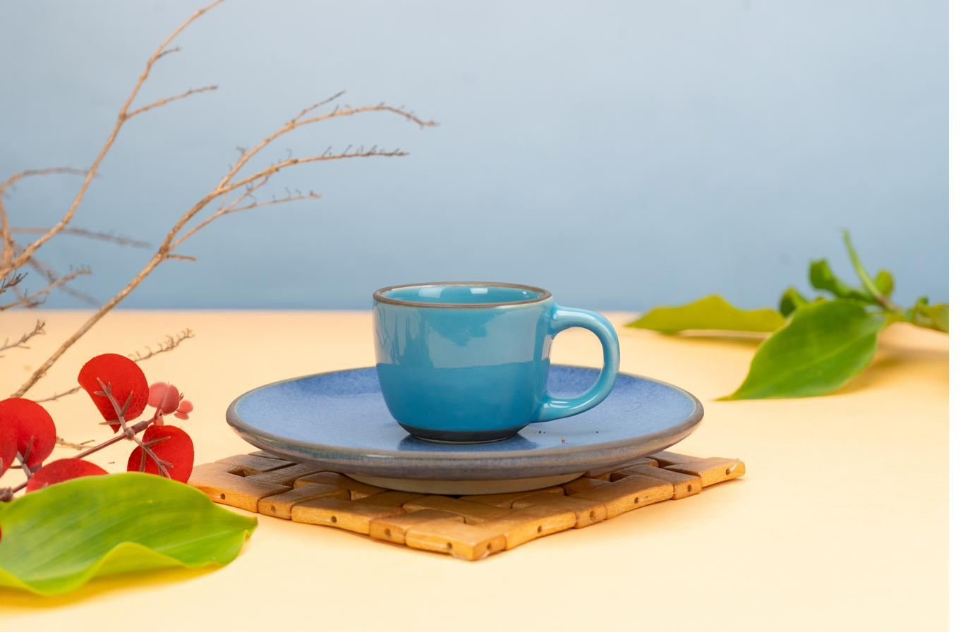 Blue stoneware cup and saucer with flowers