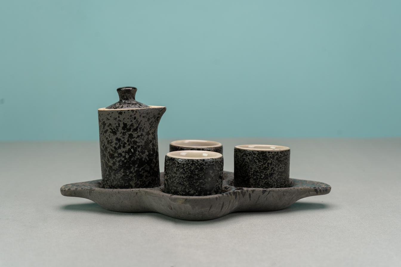 Speckled stoneware sake set after kiln firing