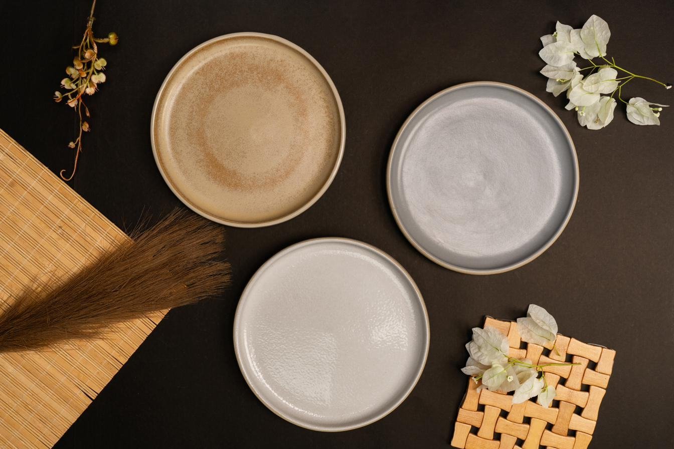 Plates on a dark surface with flowers